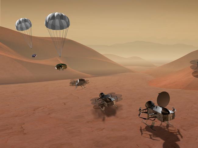 This artist's rendering made available by NASA shows multiple views of the Dragonfly dual-quadcopter lander that would take advantage of the atmosphere on Saturn's moon Titan to explore multiple locations, some hundreds of miles apart. On Thursday, June 2u7, 2019, NASA announced it would send the drone to the jovian planet's largest moon. Scientists have long considered Titan an attractive place to study whether it would be capable of supporting microbial life. (NASA via AP)