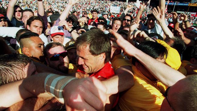 1996: Swans spearhead Tony Lockett is mobbed by fans who invaded the SCG. Lockett kicked more than 100 goals in a season on six occasions. Picture: Jay Town