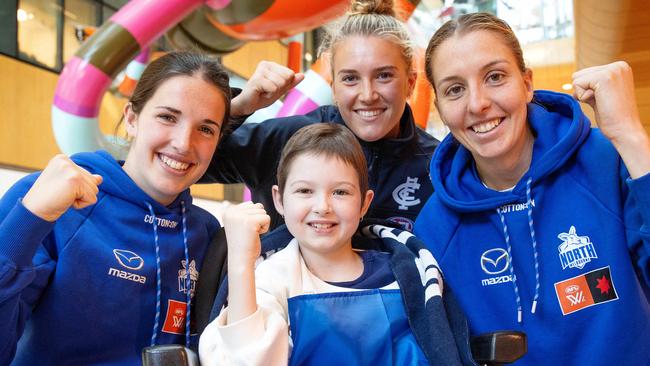 MELBOURNE, SEPTEMBER 7, 2023: Imogen Mulgrew meets Kangaroos forward Bella Eddey, Carlton midfielder Abbie McKay and Kangaroos forward Emma King at the RCH ahead of Sunday's AFLW SuperClash. Picture: Mark Stewart