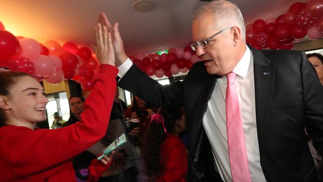 One youngster was keen to give the PM a high five of encouragement when he visited Whitehorse Netball Association in Melbourne yesterday. Picture: Alex Coppel