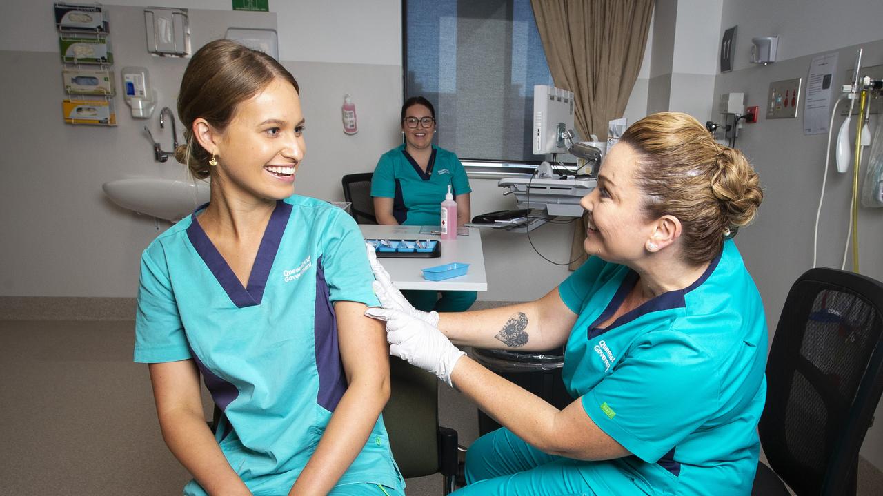 Registered Nurse Zoe Park gets Queensland’s first COVID-19 jab from clinical nurse consultant Kellie Kenway. Picture: Nigel Hallett.
