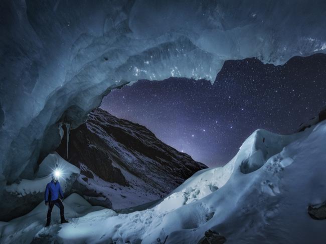 Insight Astronomy Photographer of the Year 2017 shortlist selection: Mr Big Dipper. Picture: Nicholas Roemmelt (Denmark) A stargazer observes the constellation of the Big Dipper perfectly aligned with the window of the entrance to a large glacier cave in Engadin, Switzerland. This is a panorama of two pictures, and each is a stack of another two pictures: one for the stars and another one for the foreground, but with no composing or time blending.