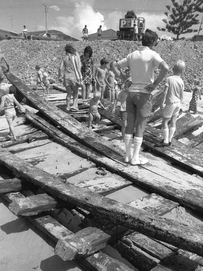 Children pick over the remnants of one side of the wreck of the "Coolangatta" in the 1970s.