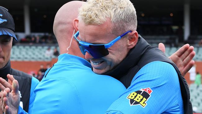 Chris Lynn receives his Strikers cap from Peter Siddle at Adelaide Oval. Picture: Mark Brake/Getty Images