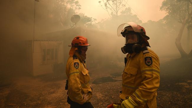 RFS crews protecting a property on Kyola Road in Kulnura as the Three Mile fire approaches Mangrove Mountain. Picture: Dan Himbrechts