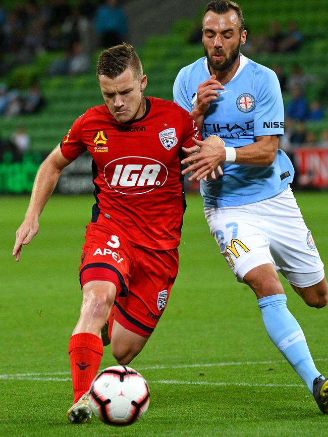 Scott Galloway on the attack under pressure from Melbourne City’s Florin Berenguer-Bohrer. Picture: Vince Caligiuri/Getty Images
