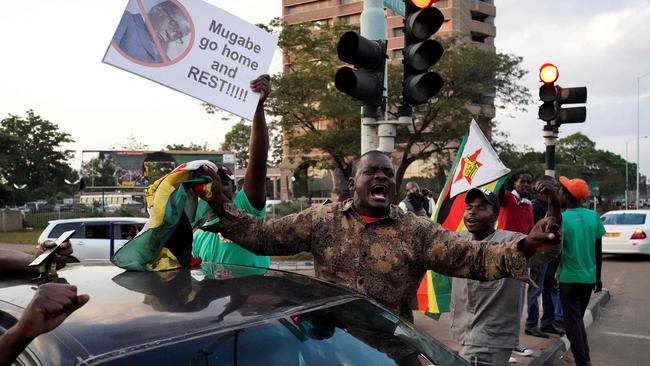 Car horns blared and cheering crowds raced through the streets of the Zimbabwean capital Harare as news spread that President Robert Mugabe, 93, had resigned after 37 years in power. Picture: Marco Longari/ AFP.