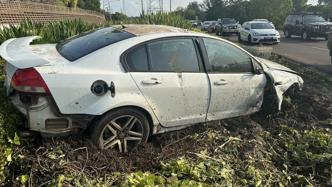 Windscreen smashed, tyre missing, airbags blown – the Holden Commodore sat in the garden bed as commuters caught a glimpse of the carnage from overnight. Picture: Elise Graham.