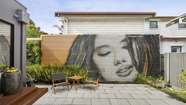 Street artist Ian Lowe created this mural in the back yard.