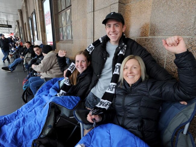 Collingwood fans Cindy Pannam with her kids Jade, 13, and Liam, 16, line up for Grand Final tickets outside the Exhibition Street Ticketek outlet. Picture: Andrew Henshaw