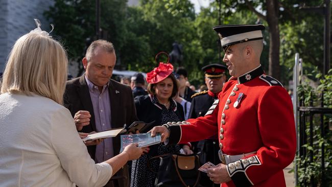 A Guardsman distributes Jubilee pamphlets to people attending the Trooping the Colour. Picture: Getty