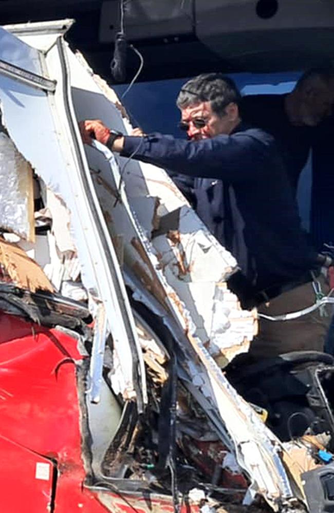 Bus driver Peter Jason Cafe looking out at the damage after the crash.