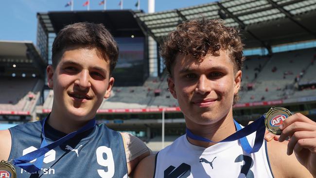 MELBOURNE, AUSTRALIA - SEPTEMBER 28: Josh Lindsay of Team Heppell and Beau Addinsall of Team Sloane pose with their best player medalsduring the Marsh AFL National Futures Boys match between Team Heppell and Team Sloane at Melbourne Cricket Ground, on September 28, 2024, in Melbourne, Australia. (Photo by Daniel Pockett/AFL Photos/via Getty Images)