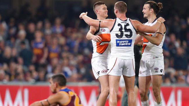 Tomlinson with close mates Phil Davis and Aidan Corr after defeating Brisbane in the semi-final last year. Picture: AFL Photos