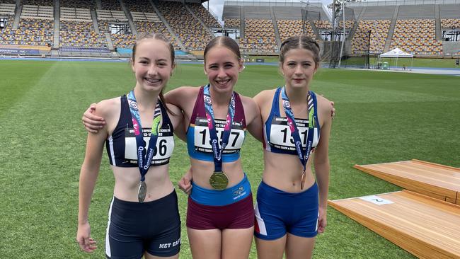 South Coast's Zarayah Williams with her hard earned gold medal, surrounded by Lily Barnett, left, and Abrielle Ball.