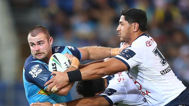 Keegan Hipgrave of the Titans is tackled during the round 25 NRL match between the Gold Coast Titans and the North Queensland Cowboys (Photo by Chris Hyde/Getty Images)