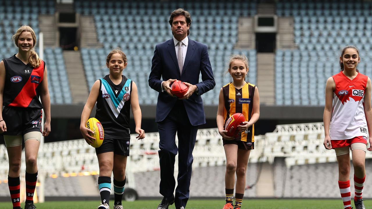 AFL chief executive Gillon Mclachlan poses with young footballers Nora Don, Fadilla Taleb, Leni Burgoyne and Layla Rabah as the AFLW expanded to 18 teams. Picture: Robert Cianflone