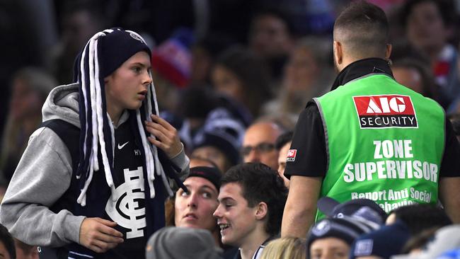 Security removes a member from the crowd on Saturday night. Picture: Getty Images