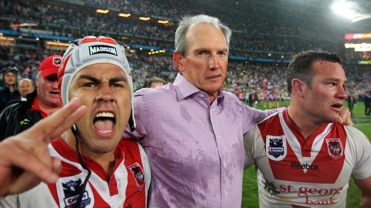 Bennett celebrates the 2010 premiership win with the Dragons – and oft-maligned playmaker Jamie Soward (L).