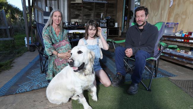 Ursula and Phil Wharton with their daughter Zoe and dog Peach at the Murwillumbah home which was badly affected by the floods. Picture: Jason O'Brien