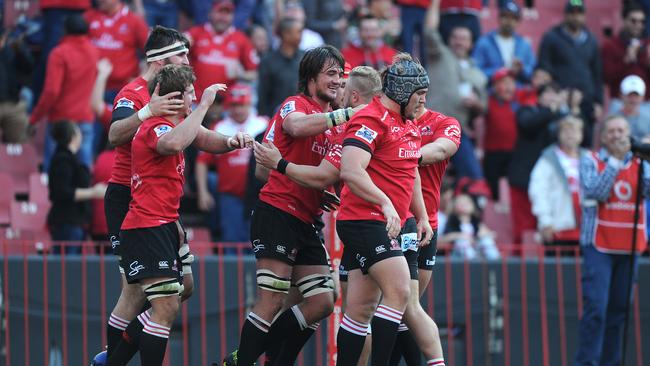 Lions flanker Kwagga Smith celebrates his match-sealing try with teammates.