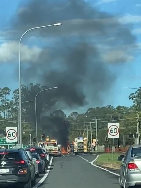 A van burst into flames producing plumes of smoke after a crash on a Logan Motorway on-ramp at Drews Road in Loganholme on Tuesday, April 4, 2023. Still from a video by Karlina Gil