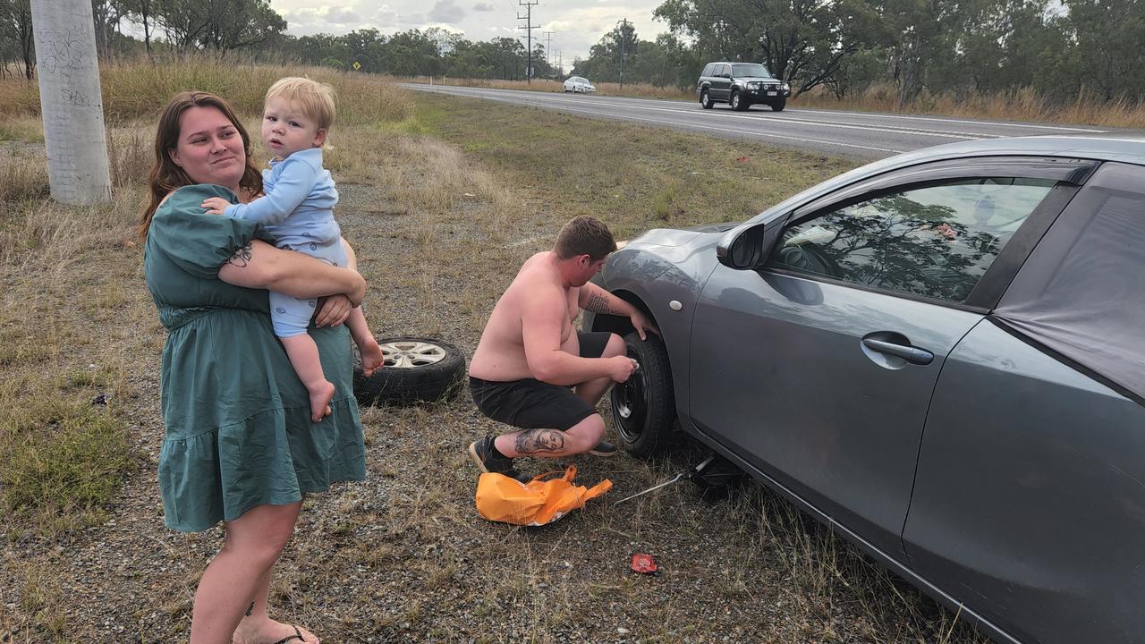 Katrina Worboys with her partner Branden Hellyer and their son Alijah, after blowing a tyre in a massive pothole on the Bruce Highway near Bajool. Photo Darryn Nufer.