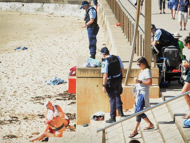 Beachgoers are asked to move on by police at Dee Why, a known hotspot for the virus. Picture: Jeremy Piper