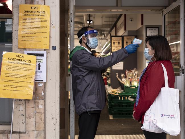 A woman has her temperature checked before entering a Chinese supermarket in London’s Soho. Picture: Getty Images