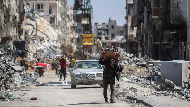 People remove possessions from their destroyed homes in Khan Younis. Picture: Getty Images