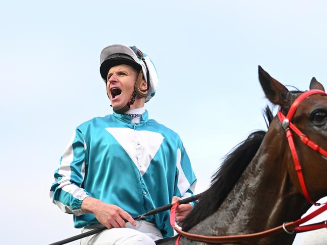 HONG KONG, CHINA - DECEMBER 08: James McDonald riding Romantic Warrior reacts with the crowd after winning Race 8, the Longines Hong Kong Cup during racing at Sha Tin Racecourse on December 08, 2024 in Hong Kong, China.  (Photo by Vince Caligiuri/Getty Images)