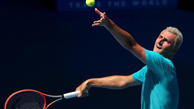 Bernard Tomic serves during a practice session ahead of the 2022 Australian Open. (Photo by Kelly Defina/Getty Images)