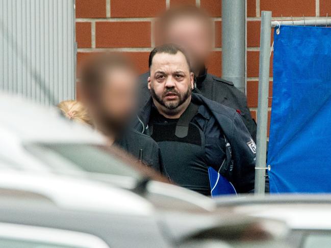 Former nurse Niels Hoegel, accused of killing more than 100 patients in his care, wears a bullet proof vest as he is lead out of the court compound. Picture: Hauke-Christian Dittrich/ DPA/AFP