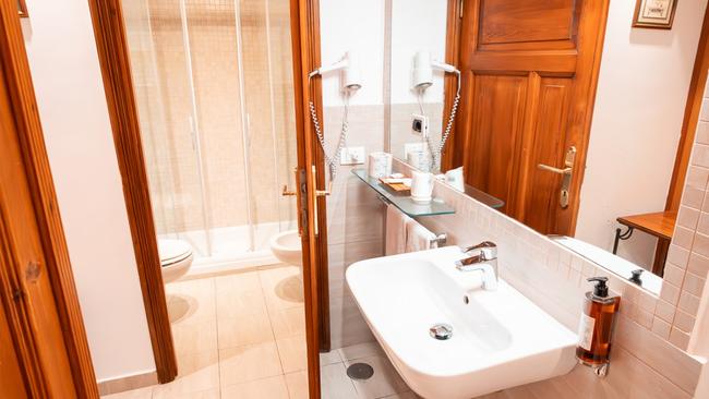 The walls are decorated with tasteful prints of historical Rome - like windows into the past – and a commanding desk stakes out the room as my kingdom. The bathroom has a large spa bath as well as a shower, and a separate chamber for the inevitable bidet. While the suite door opens with a genuine, simple, rustic key-shaped key, the reception is only staffed until 8pm. Guests coming back later in the evening must use a smartphone and a weblink (not even an app!) to unlock the street door. This means that I spend the whole night worrying that my ageing iPhone will run out of battery.