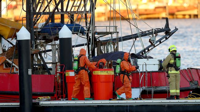 Police and Fire and Rescue NSW personnel search the fishing trawler for drugs after those on board the vessel were arrested. Picture: Toby Zerna