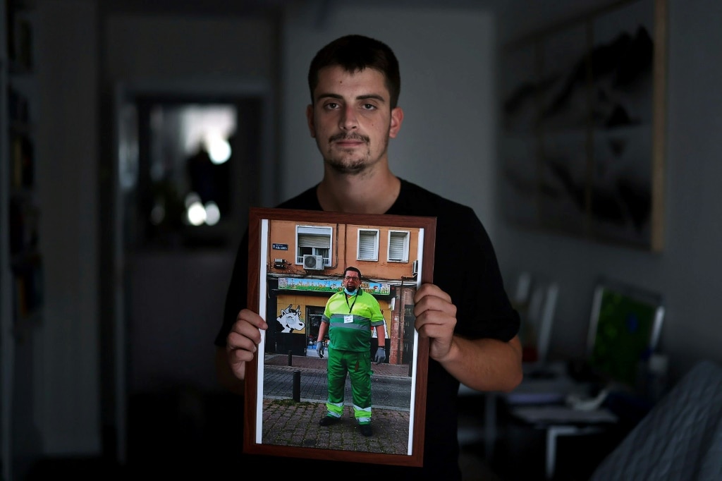 Miguel Angel Gonzalez holds a pictures of his father, who died from heatstroke