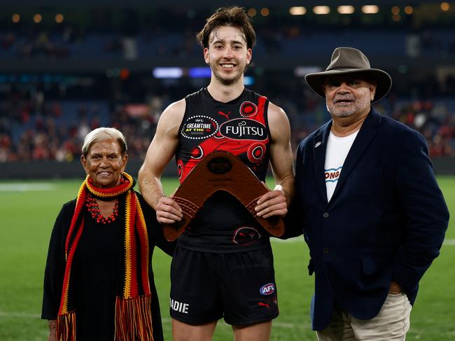 Nic Martin is presented with the Yiooken Trophy by Aunty Pam Pedersen (left) and Michael Long (right). Picture: Getty Images
