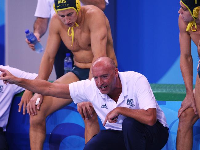 Coach John Fox talks to his players during a break at the 2008 Beijing Olympics.