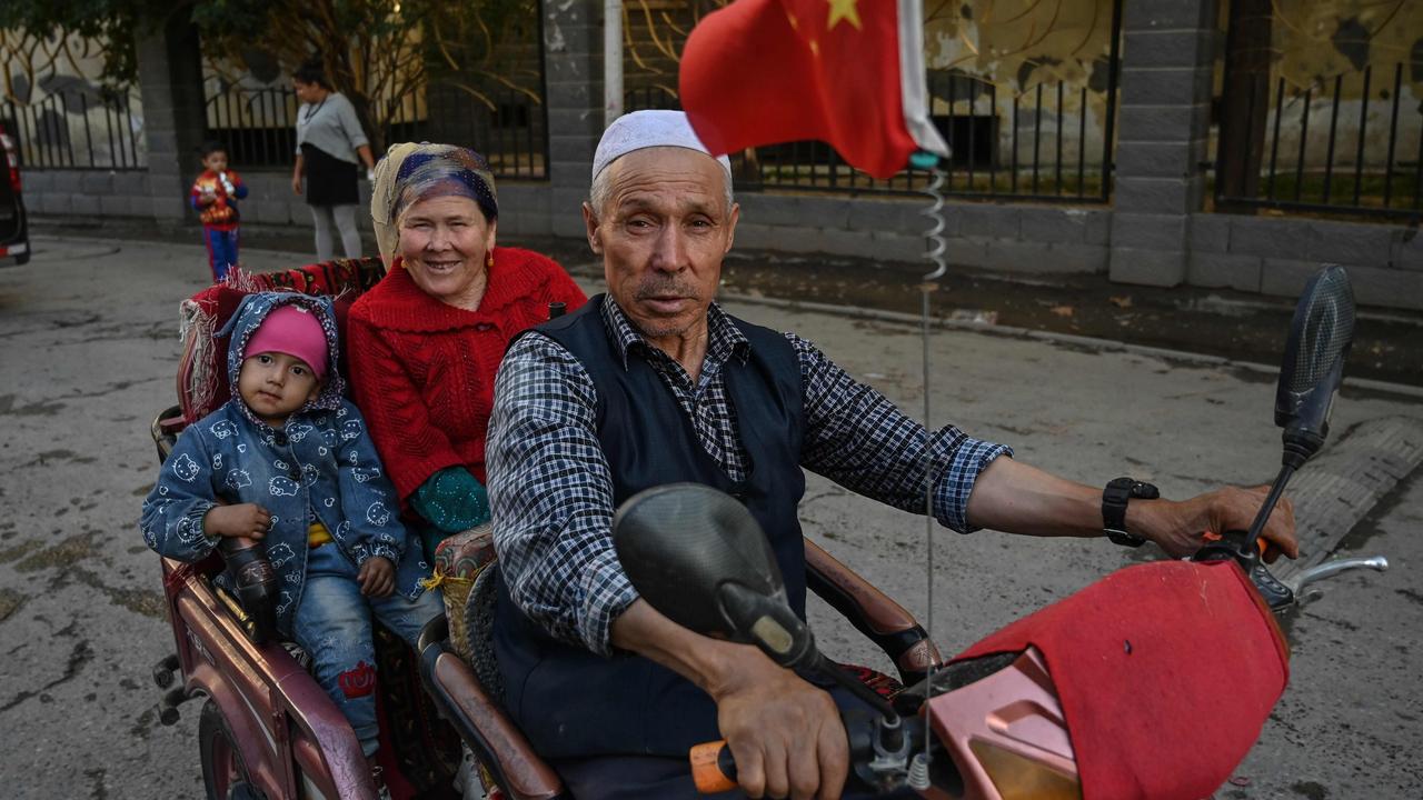 A family an ethnic Uighur neighbourhood. Chinese authorities are carrying out forced sterilisations of women in an apparent campaign to curb the growth of ethnic minority. Picture: HECTOR RETAMAL / AFP.