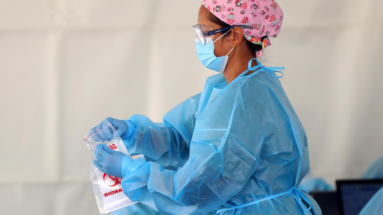 A nurse with a COVID-19 test in Auckland, New Zealand this week. Picture: Hannah Peters/Getty Images