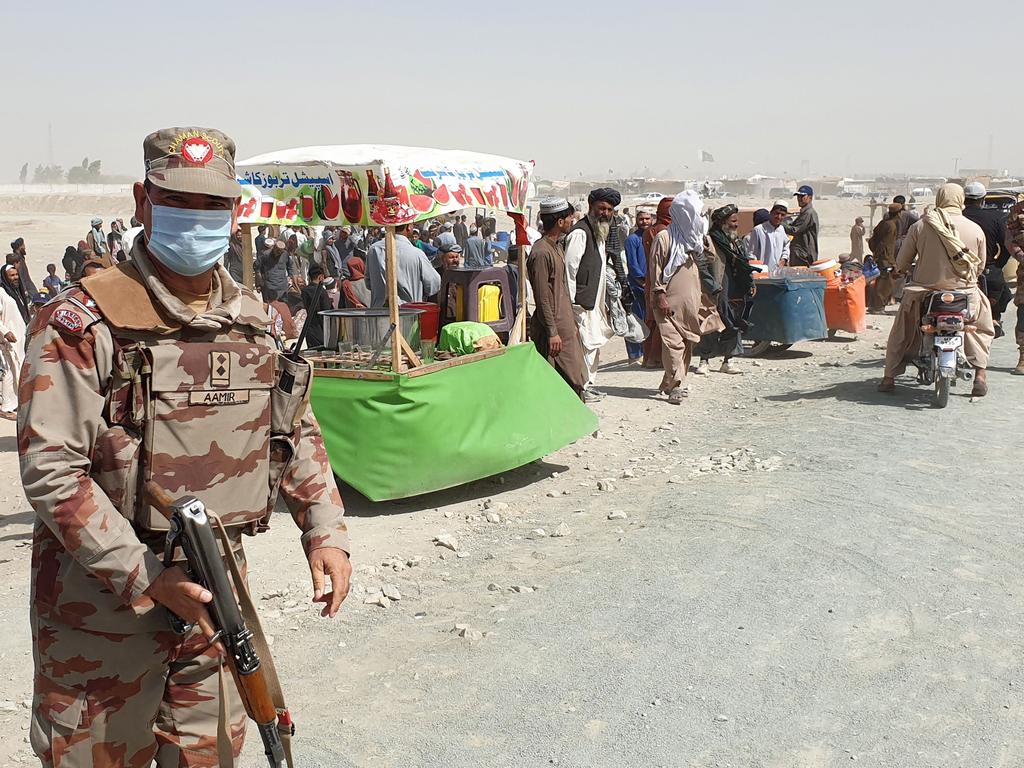 An army soldier patrols as stranded people wait for the reopening of the border crossing point which was closed by the authorities, in Chaman on August 7, 2021, after the Taliban took control of the Afghan border town. Picture: Asghar Achakzai/AFP