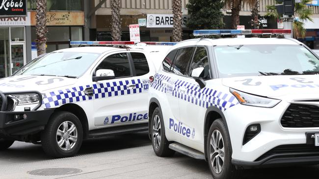 Police on the corner of Little Malop and Moorabool streets. Picture: Alan Barber