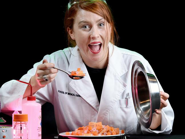 08/06/16 Dinner with a Scientist. Young scientist Hannah Wardill wearing lab coat (and hopefully safety goggles on top of her head) sitting at a dining table holding a kinfe and fork about to tuck in to some science. Pic Roy VanDerVegt