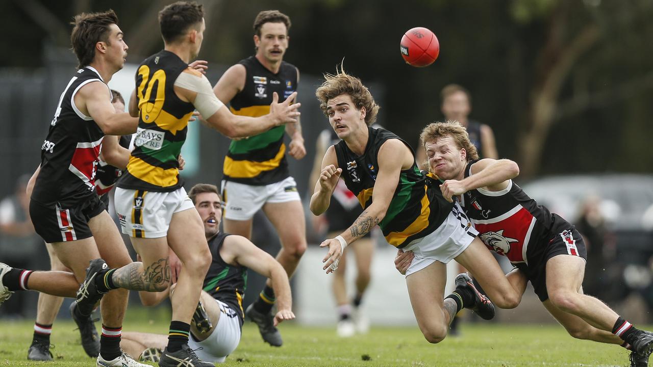 MPNFL: Dromana’s Jai Taylor fires out a handball under pressure from Brayden Chapple of Bonbeach. Picture: Valeriu Campan