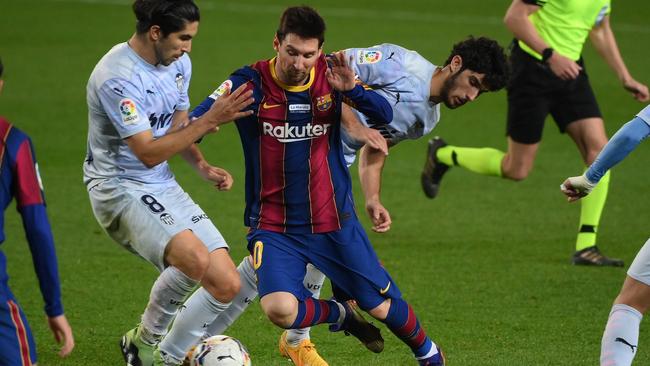 Barcelona's Lionel Messi vies with Valencia's Goncalo Guedes at the Camp Nou stadium in Barcelona