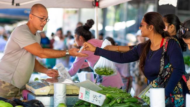 A vendor makes a sale at the Rapid Creek markets yesterday. Picture: Che Chorley