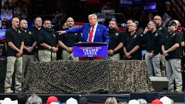 Republican presidential candidate Donald Trump speaks alongside National Border Patrol Union members at a campaign rally in Arizona. Picture: AFP.