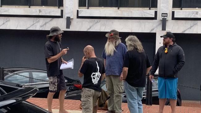 Dylan Wilson (far left, in bucket hat) speaks to supporters after being granted bail at the ACT Magistrates Court. Picture: Julia Kanapathippillai