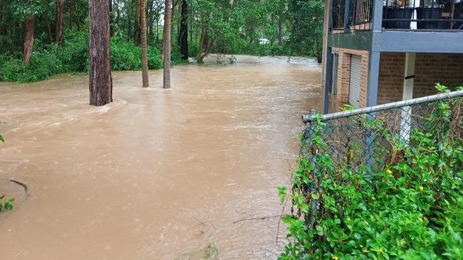 Flood water laps at homes on Taloumbi Road, Coffs Harbour on Tuesday afternoon. Picture: Nathan Trivett