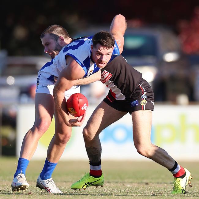 Corowa-Rutherglen’s Jordan Foote is tackled by Myrtleford’s Matt Munro. Pictures: Yuri Kouzmin